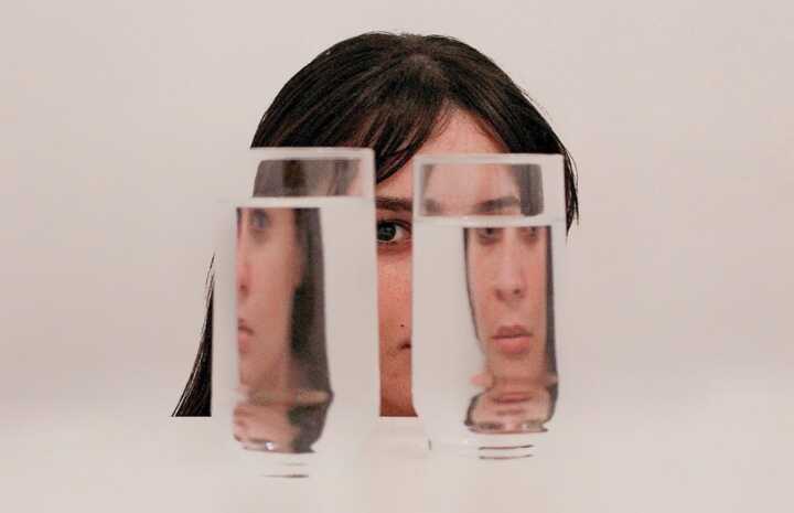 two clear drinking glasses with water